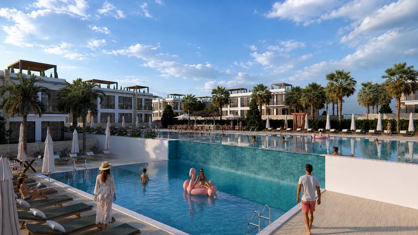 Communal outdoor pool with sun loungers between the blocks