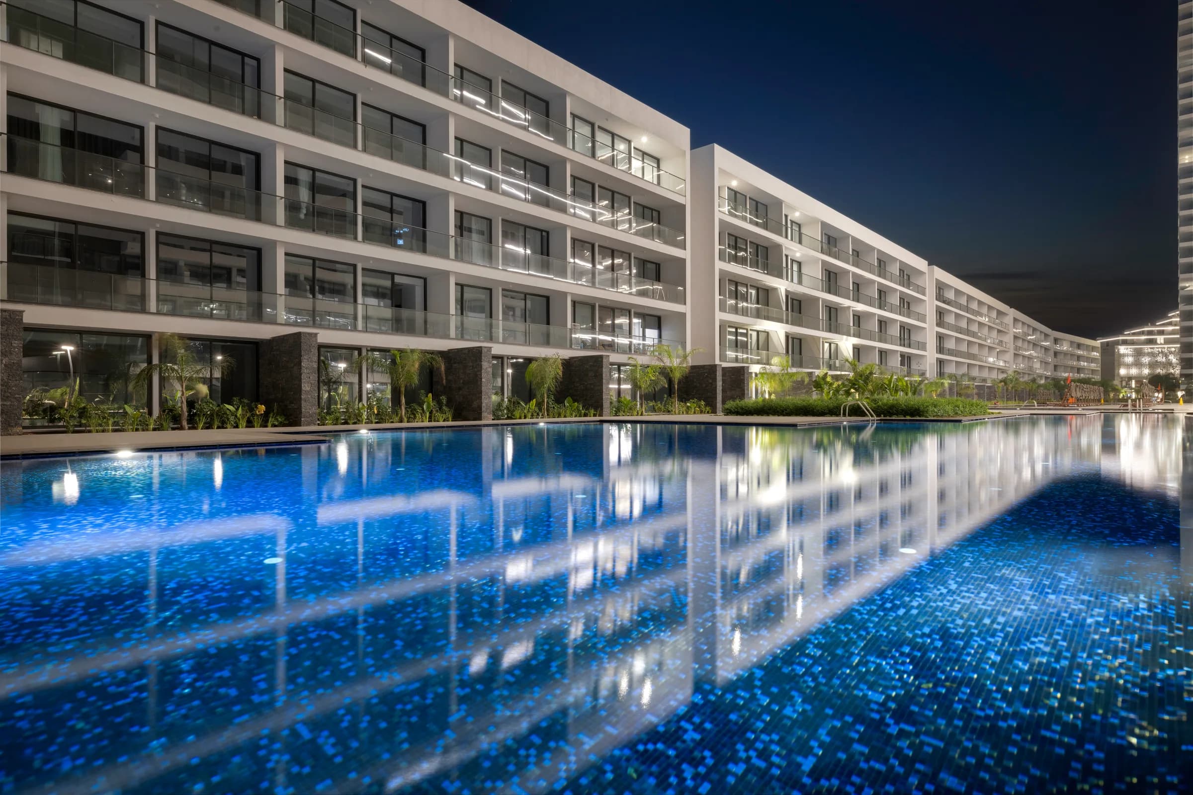 Low-rise blocks along a long pool