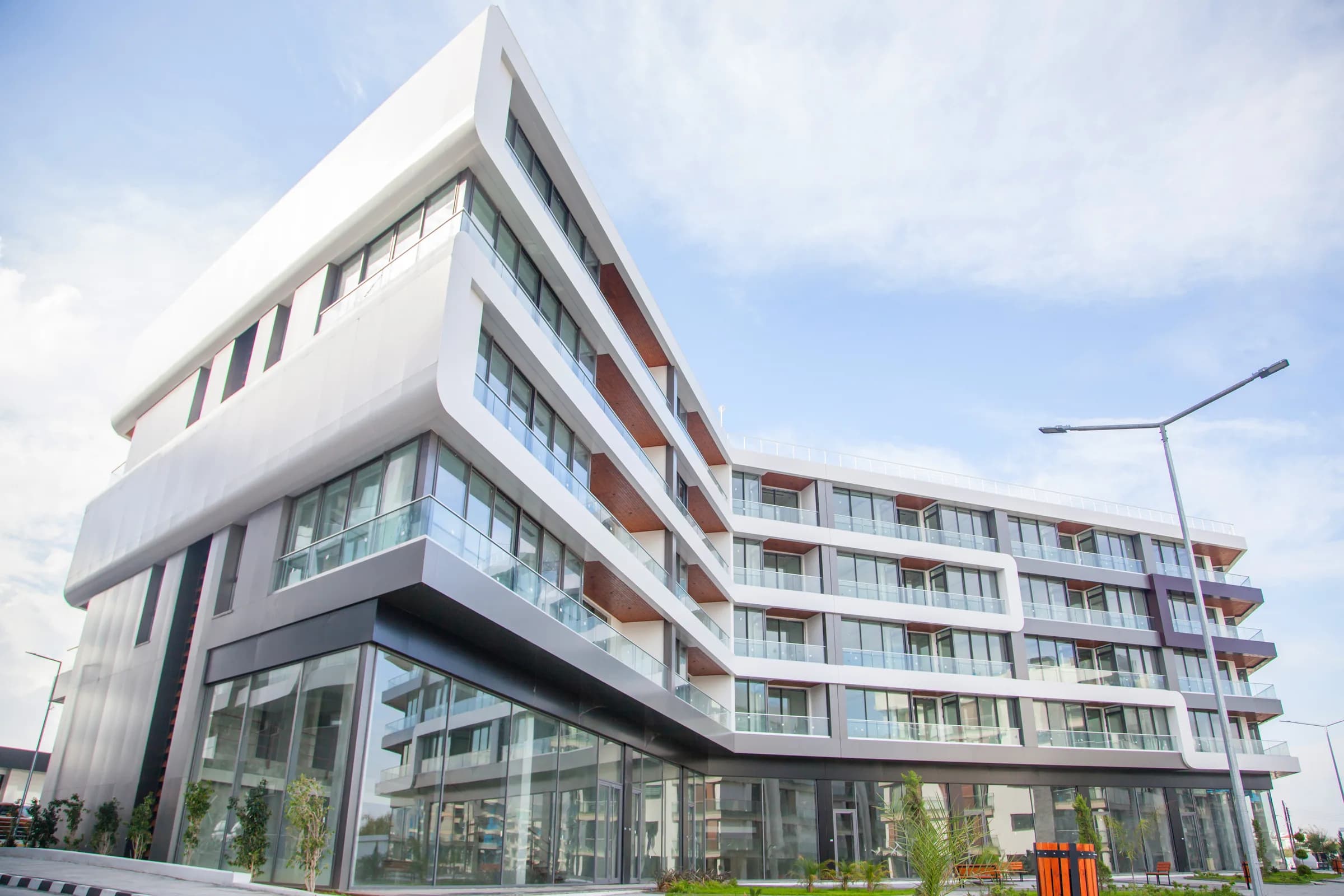 Corner of a Residence building with glazed shops below the flats (photo)