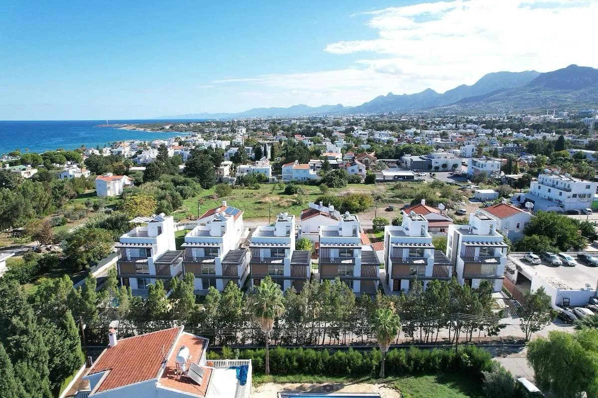 The villas from the air, with the sea on the horizon