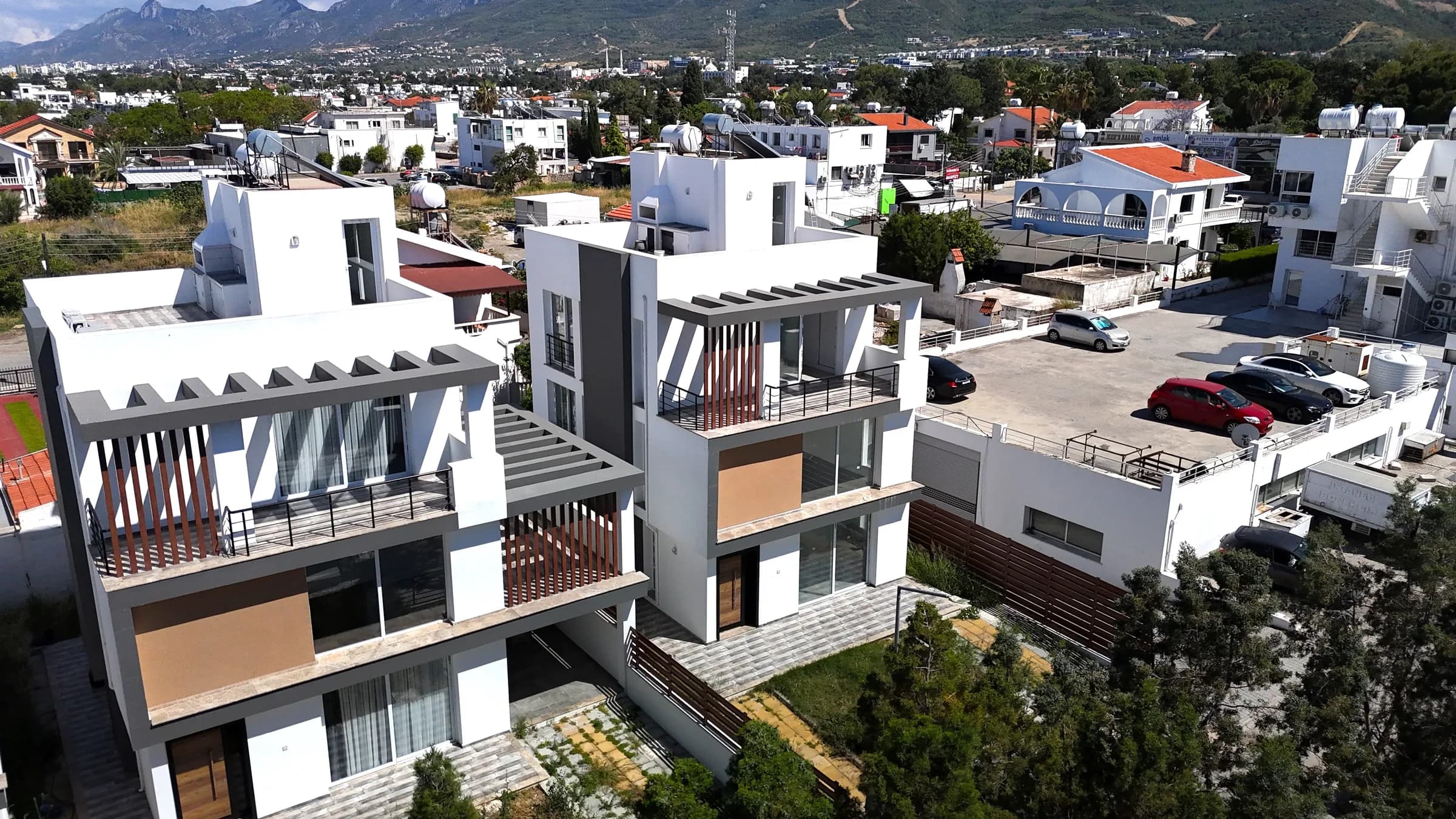 Villa façades with timber-effect panels and balconies